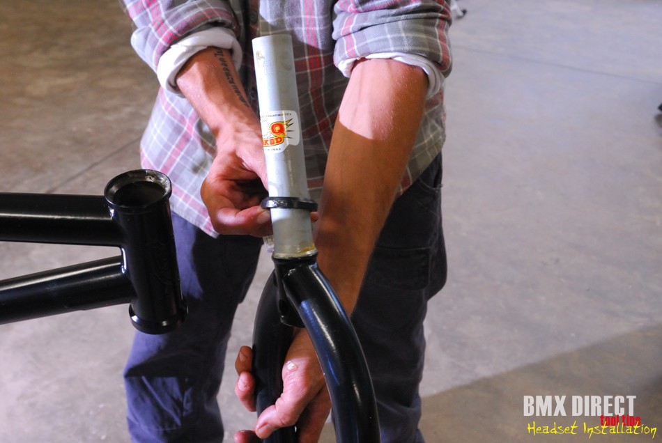 Add a little grease to your fork race and slide the bearing down the steerer tube. Take note of which way the bearing goes on. Seat the bearing nicely on the fork and the fork into place seating the bearing snugly into the frame.