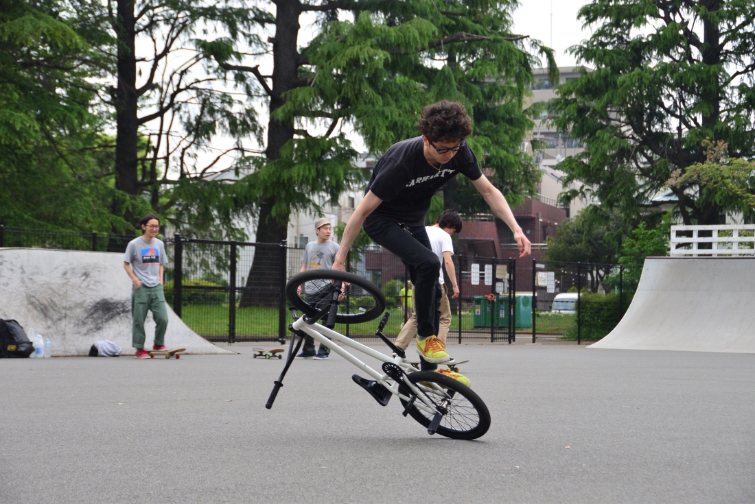 Atushi, BMX shop owner and rider, shreds on the back wheel! Komawaza Park.